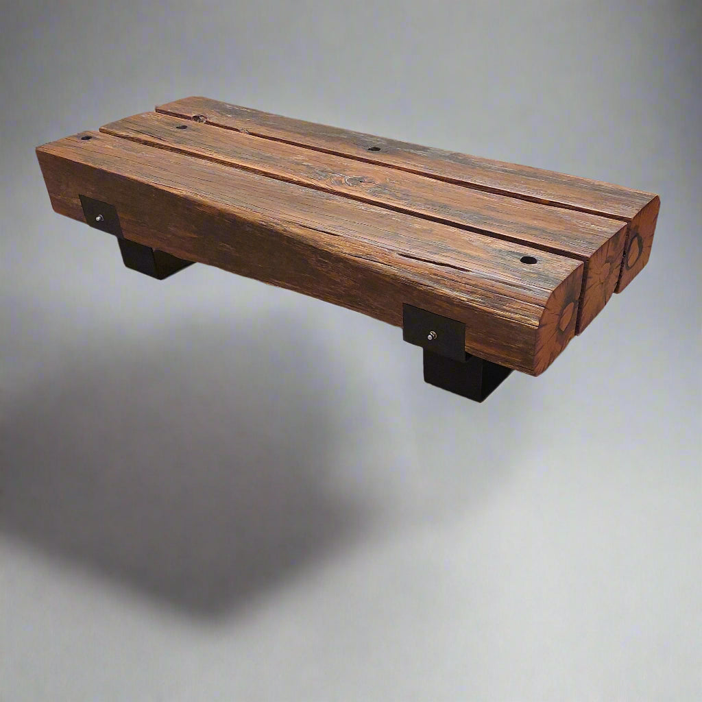 Wooden bench on a carpeted floor with people partially visible in the background