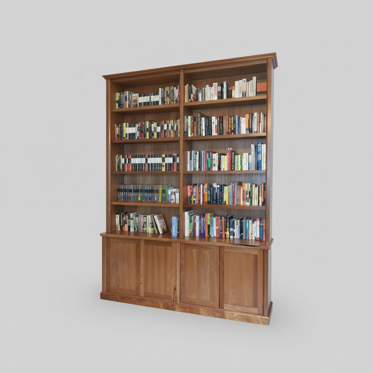 A large custom wooden bookshelf with upper shelves filled with books, and lower cabinets, positioned against a wall on a wooden floor.