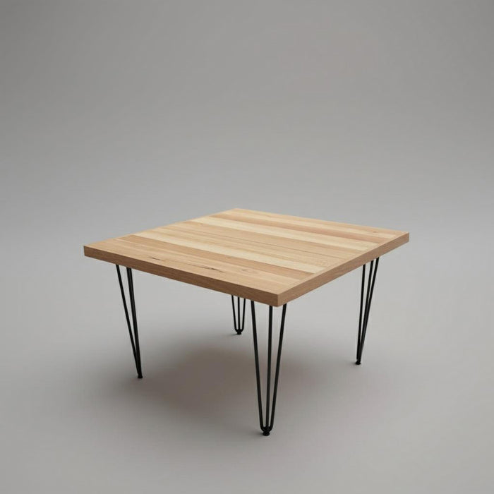 Wooden table with black metal legs on a gray background
