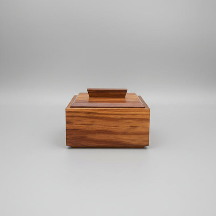 Wooden box on a wooden surface with a dark background