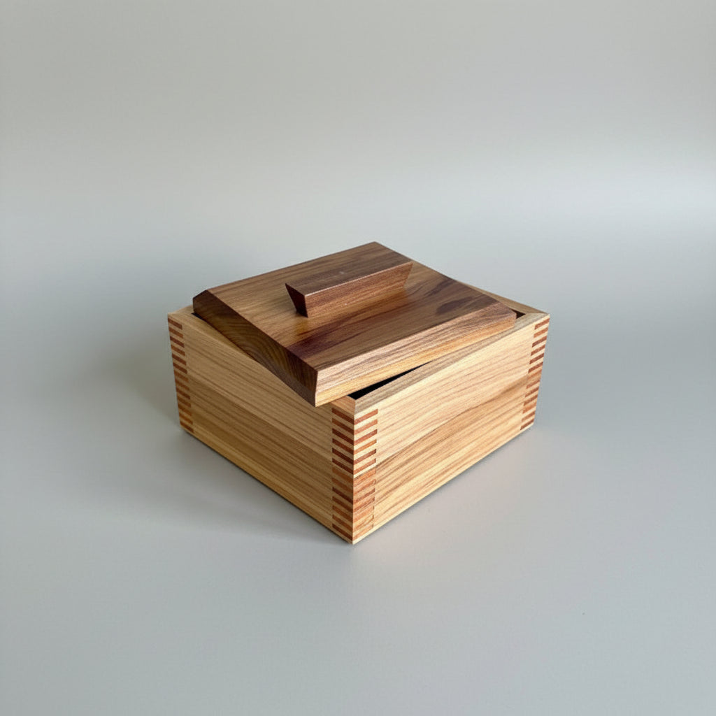 Wooden box with a hinged lid on a wooden surface