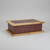 Wooden box with a glass lid on a wooden surface