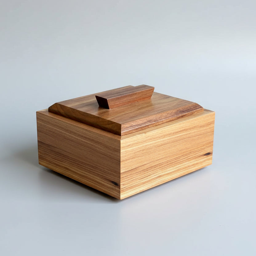 Wooden box with a lid on a wooden surface