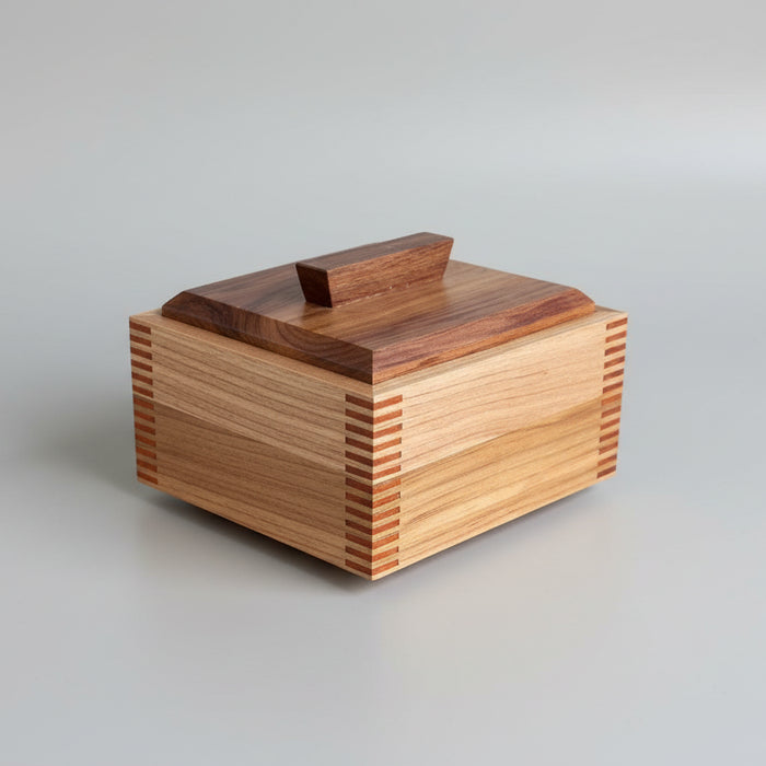 Wooden box with multicolored slats on a wooden surface
