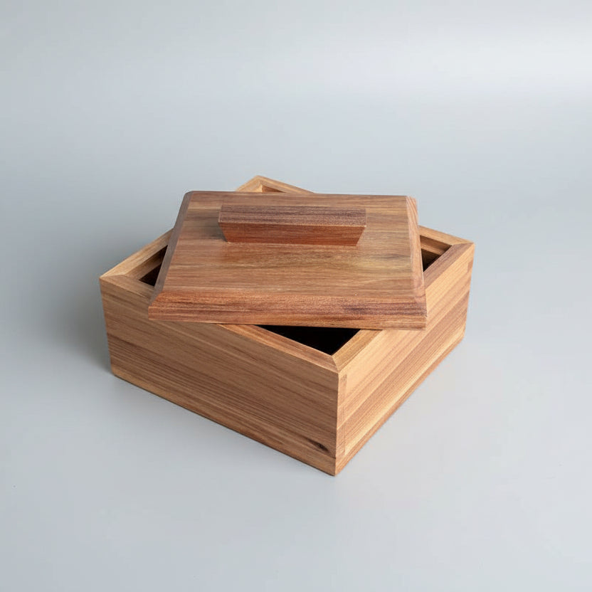 Wooden box with a lid on a wooden surface
